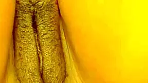 Beautiful black babe strips naked showing off her impressive clitoris while having a self-fucking session