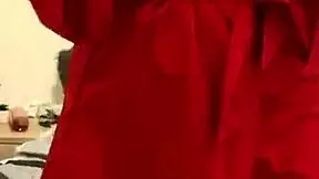 It’s best described as young and beautiful, brunette lady wearing only red underwear and a beautiful smile on her face while she is enjoying masturbation