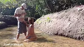 Beautiful young Latina maid shocks farmer while he is taking a river bath
