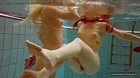Two beautiful ladies engage in pool play bare knuckles without had-on