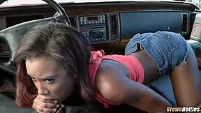 A young black woman performs oral sex on a white man
