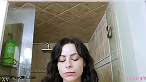 A sexy dark-haired model takes a bath with elegance